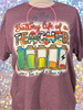Heather Maroon bleach patterned tee with image of a battery going down each day and quote Battery Life of a Teacher in animal prints and rainbow colors.