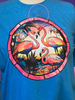 Heather Sapphire tee with three flamingos in a stained glass round window.