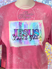 Heather Heliconia bleach patterned tee with Jesus Loves You in blue, pink, purple, and glitter patterns.