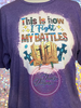 Heather purple bleached tee with saying This Is How I Fight My Battles with crosses and bible.